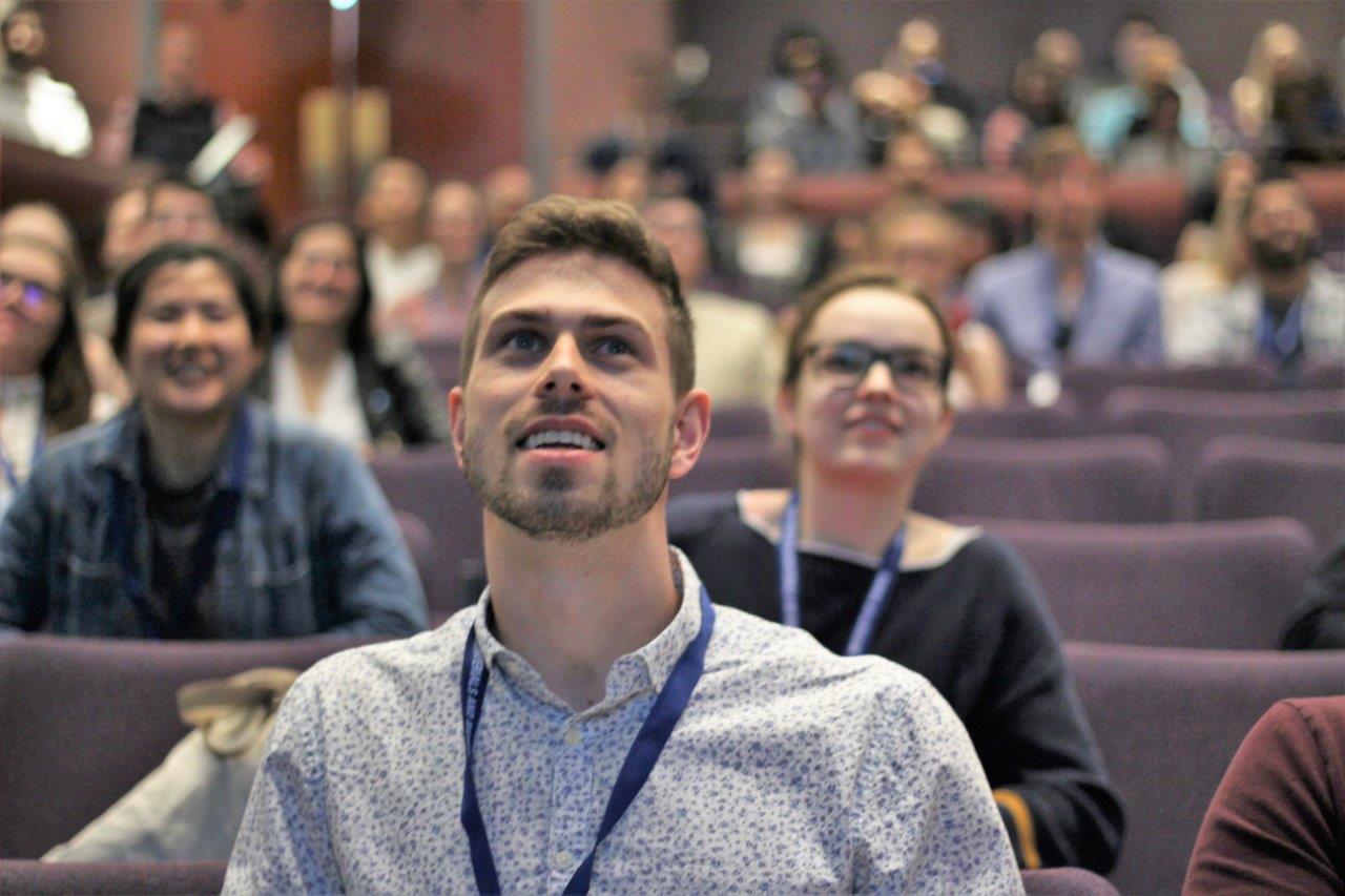 students smiling while participating in a lecture