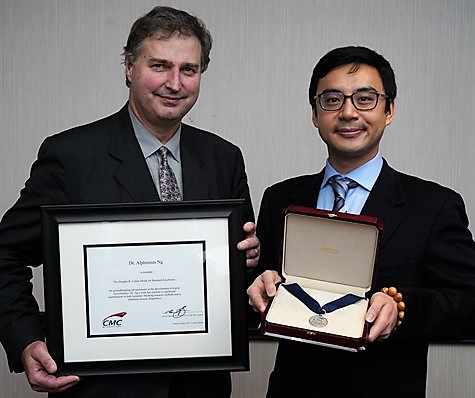 Dr. Alphonsus Ng holding the Douglas R. Colton Award for Research