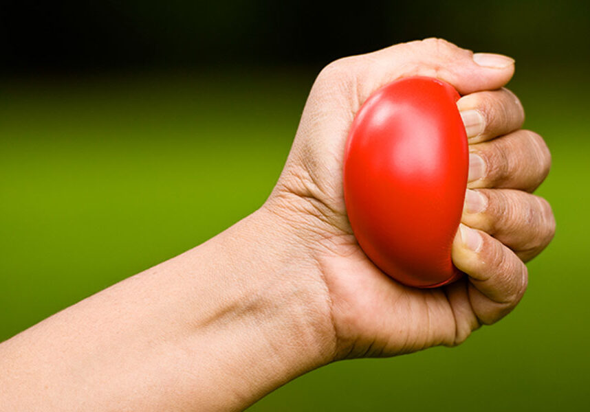 Hand holding red ball